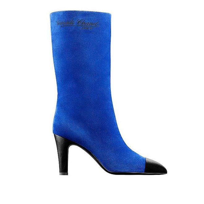 Make an entrance with this royal blue suede boots with Coco Chanel's embroidered on it—just as she would.