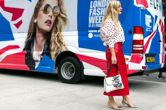 Kate Foley illustrates the ideal modern work ensemble in a midi red skirt with a bold-shoulder printed blouse and ladylike sling-backs. Photo: Getty 