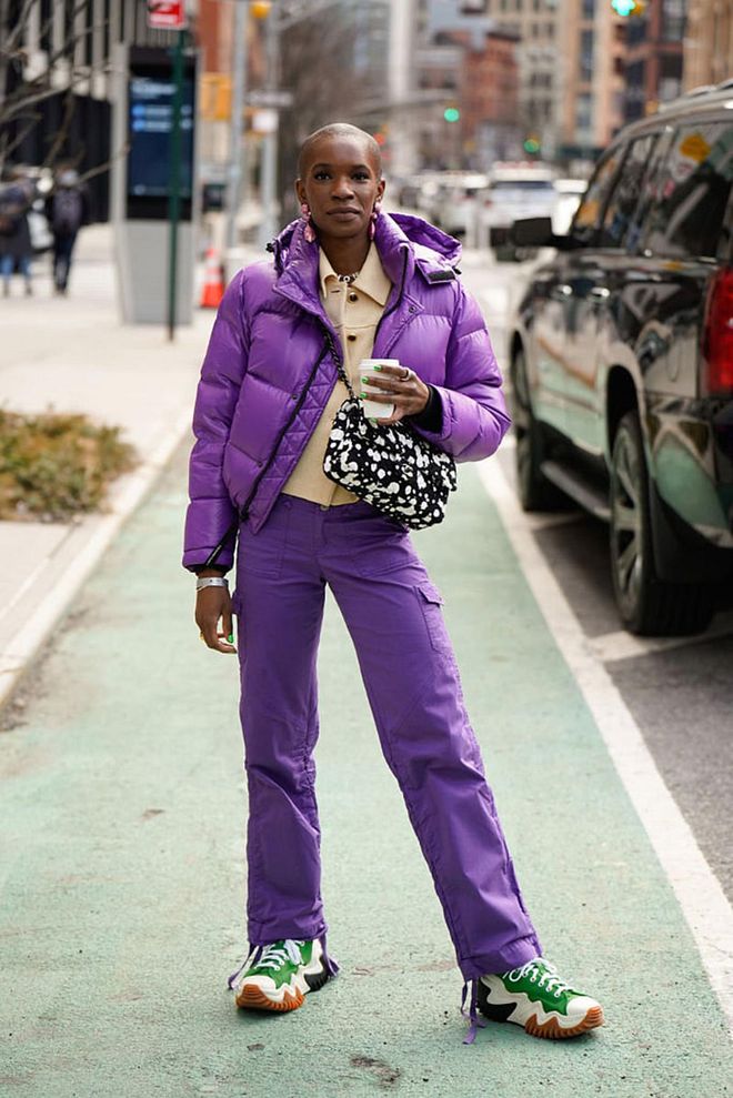 NEW YORK, NEW YORK - SEPTEMBER 13: Monica Ahanonu wearing a purple puffed jacket with pants of matching shade, over a cream blouse, along with green chunky shoes. (Photo by Jared Siskin/Getty Images))