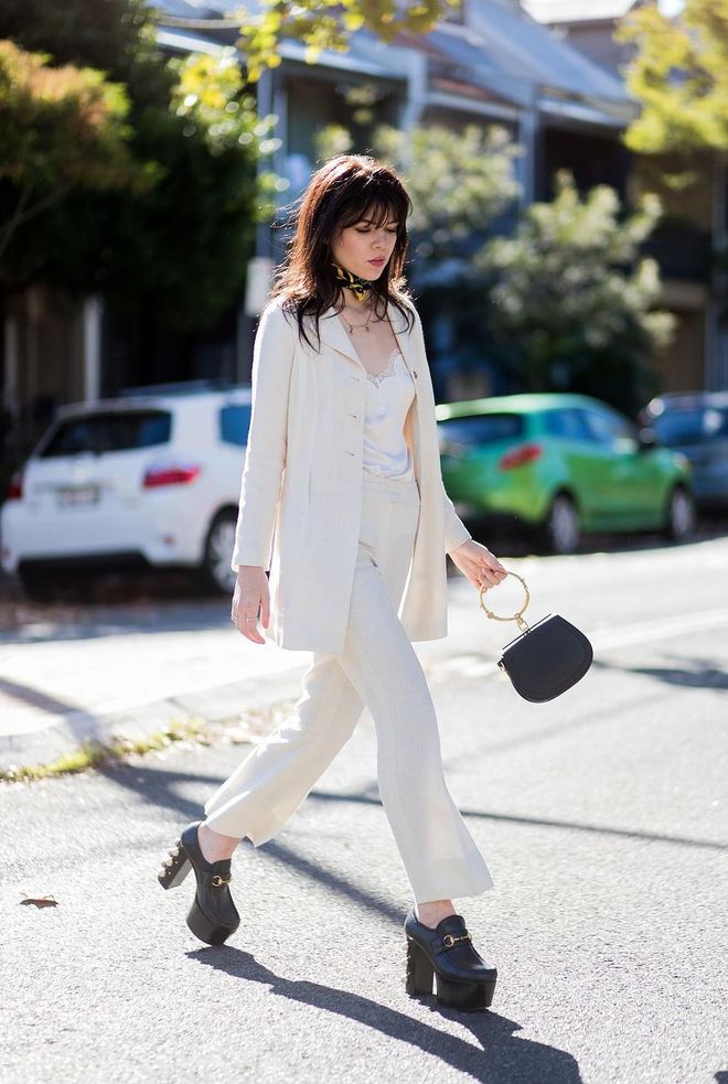 Ondine Daisy Purinton-Miller wearing a white suit, Gucci shoes, Chloe bag. Photo: Getty 