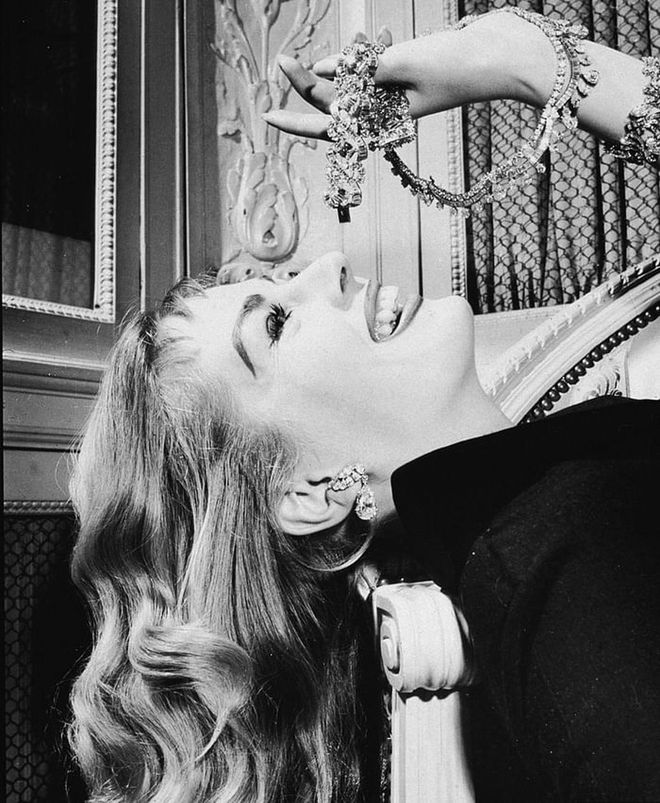 The Swedish actress posing with Cartier baubles like grapes, in the 1960s. Photo: Getty 