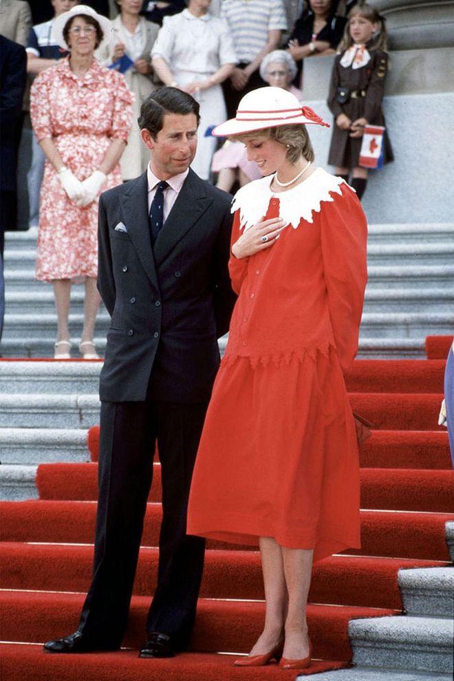 In a red and white dress and matching hat while on a royal visit to Canada with Prince Charles. Photo: Getty