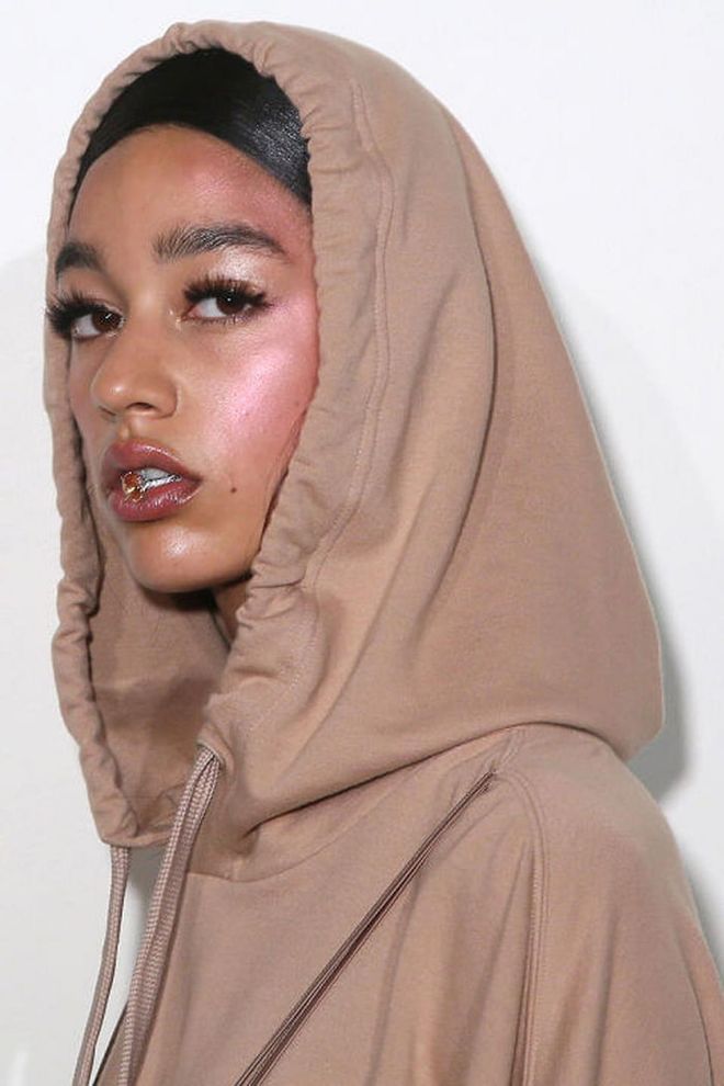 The Look: Pink Glow
How-To: Baby pink was the key colour for Rihanna's second Fenty Puma collection. The shade was used in head-to-toe looks and on everything from baseball caps to lace-up stiletto booties. It was also the key to the beauty look, which relied heavily on only two thing: serious false eyelashes, and an intense pink cheek highlight. On the cheeks, makeup artists applied a bold sweep of Marc Jacobs Beauty Air Blush Soft Glow in Lush and Libido all the way up to the cheek and toward the temples. Then the Marc Jacobs Beauty Glistening Illuminator, a pearly cream highlighter, was rolled across the temples. The effect was an intense pop of pink shimmer, but in this day and age, there's no such thing as too much highlighter. 