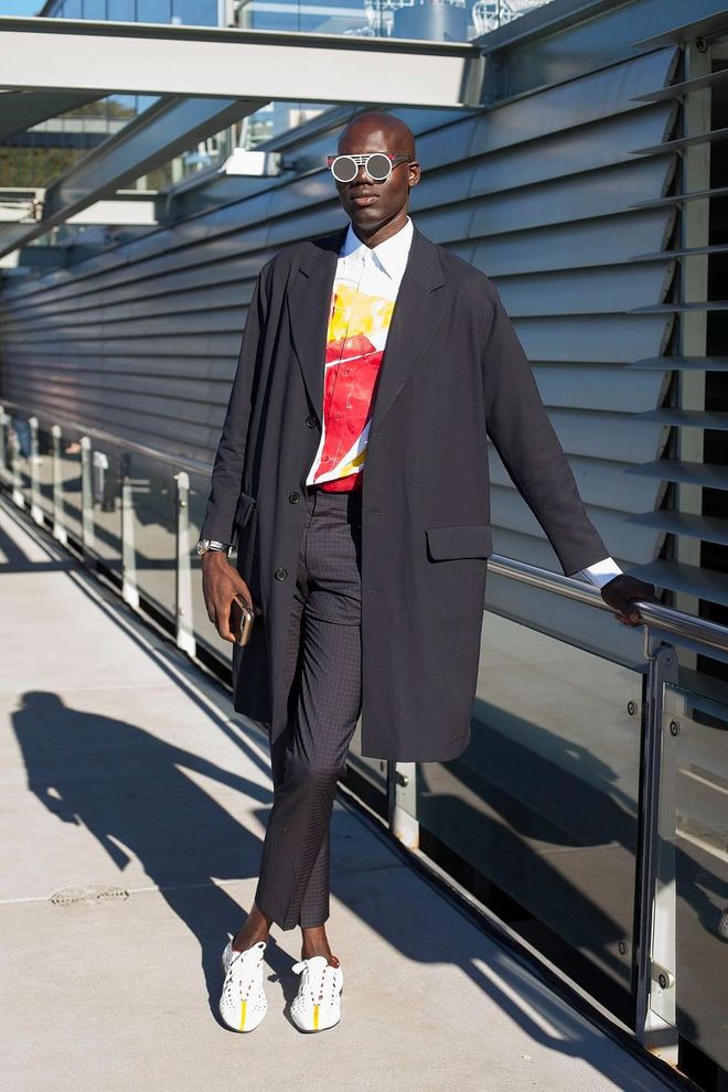 Contributor to L'Officiel Ukraine and New York Style Guide Badara Ndiaye wearing a Sandro coat, Prada shoes, Hugo Boss trousers and Peter and May sunglasses. Photo: Getty 