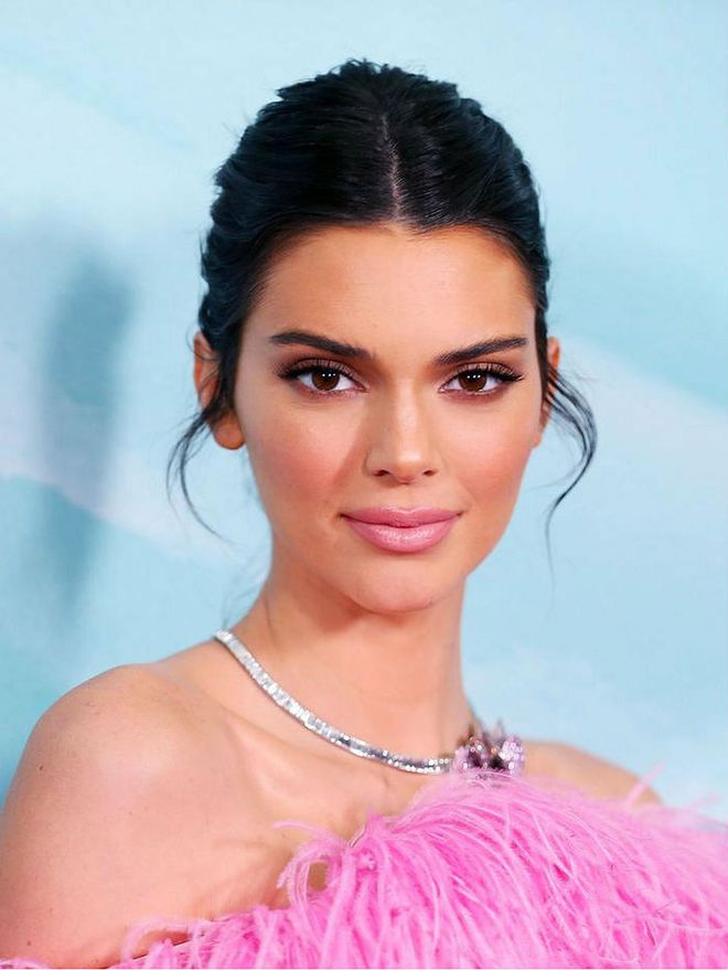 A new take on tendrils, Jenner wore pink lipstick and flirty lashes paired with shorter and curled tendrils right by her ears. Photo: Getty  