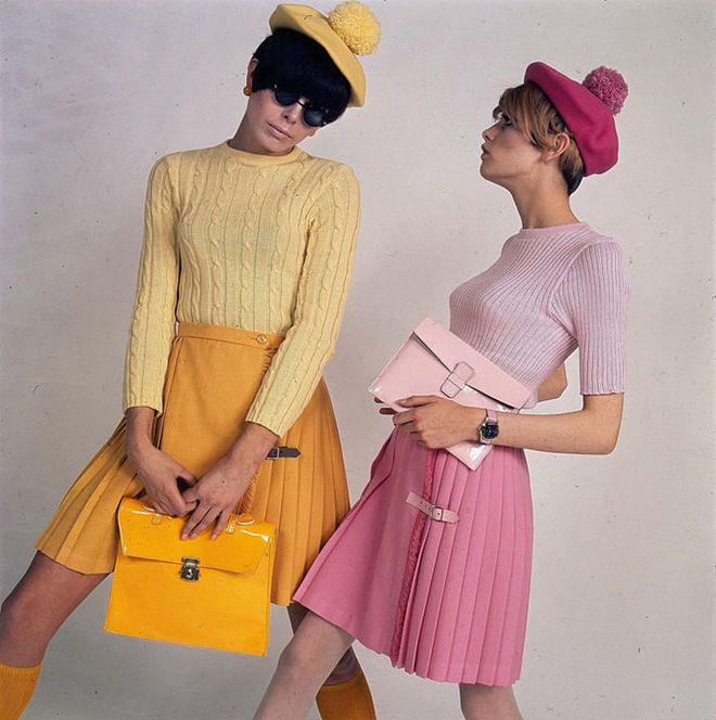 Twiggy (right)poses with another model in coordinating pleated skirts, sweaters and berets. Photo: Getty