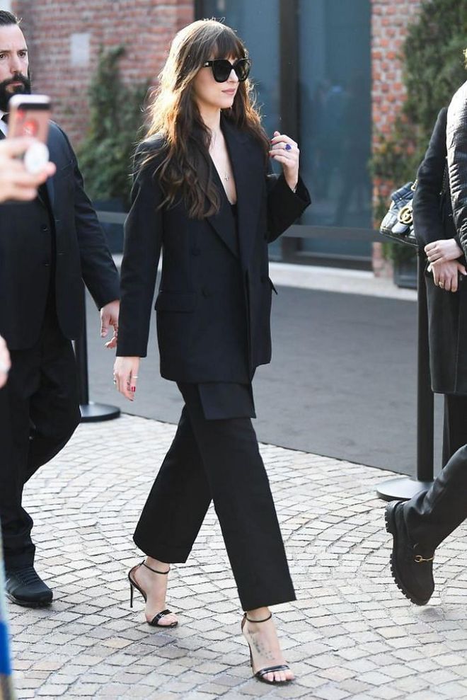 Dakota Johnson was seen arriving to the Gucci show in a black suit and strappy heels.

Photo: Jacopo Raule / Getty