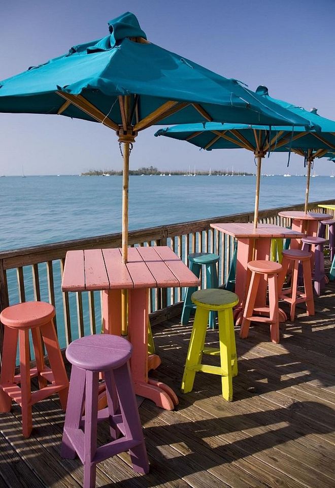 Part of the reason this beach town is known for being a hot party spot is the vibrant and colorful colors it exudes. It doesn't hurt that the water is a teal color, providing the perfect backdrop for drinks by the sea on a neon stool.