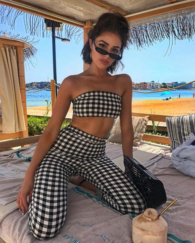 Here she's wearing a black and white co-ord checkered tube top and pants from Revolve. Photo: Instagram/@oliviaculpo