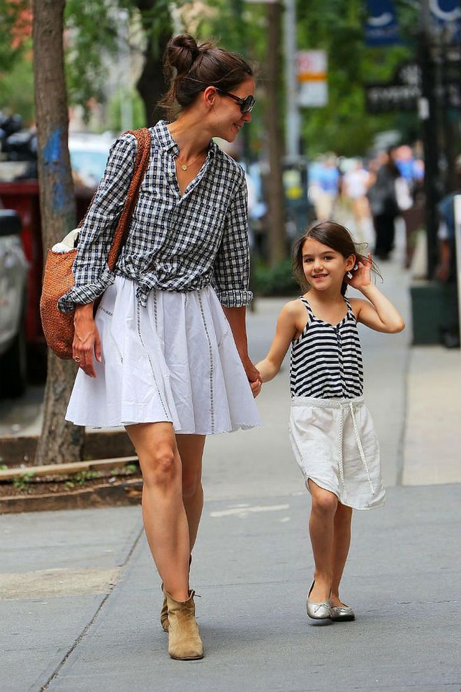 In the past, Katie Holmes has talked about how her daughter Suri is her style inspiration. So perhaps the young tot inspired this mommy-and-me look the two wore while out in New York. Both in white skirts and black and white tops, Katie topped her outfit with Western suede booties while Suri opted for silver ballet flats. Photo: Splashnews
