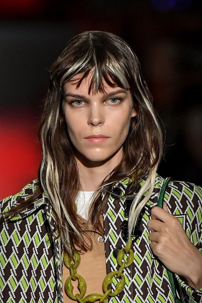 Bold highlights are key for Prada's show, complete with choppy bangs and lots of layers for a rock and roll vibe. The eyes are emphasized with a light haze of smoke. Photo: Getty 