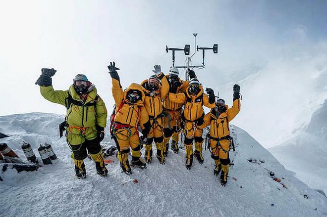 Members of the multidisciplinary team pose for a portrait after successfully installing weather stations on Mt Everest.
