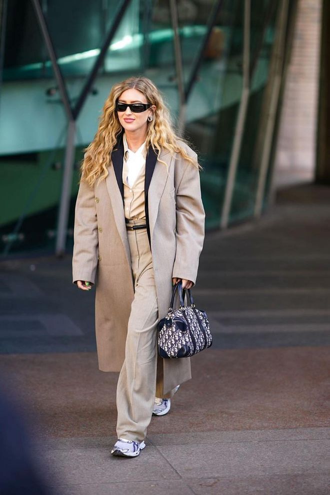 Elevate the simpler pieces in your wardrobe for the office with a well-tailored overcoat and luxury accessories. For those who are commuting, try wearing creased trousers with sturdy leather sneakers to give the look a practical edge.

Photo: Edward Berthelot / Getty