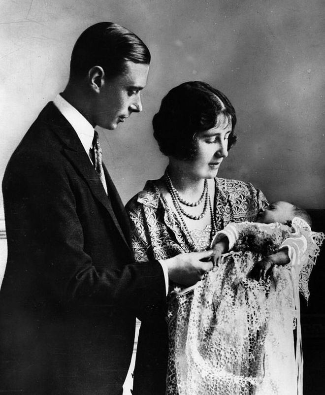 King George V and Queen Mary's son, George, Duke of York (the future King George VI) and his wife Elizabeth, Duchess of York welcomed their first child and future Queen, Princess Elizabeth on April 21, 1926. In this photo, the royal couple looks dotingly at their daughter at her christening, a month after she was born.