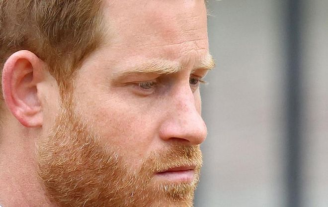 Prince Harry Duke of Sussex reacts as he attends the state funeral