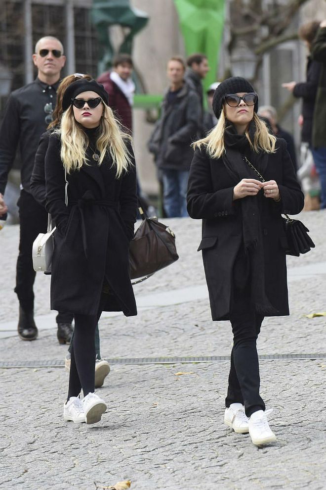Reese Witherspoon and her lookalike teenage daughter, Ava Phillippe, had us seeing double while out in Paris for a family vacation. Both wore all-black looks—hats, sunglasses, coats and leggings—paired with stark white sneakers for a chic matching look. Photo: Splash News