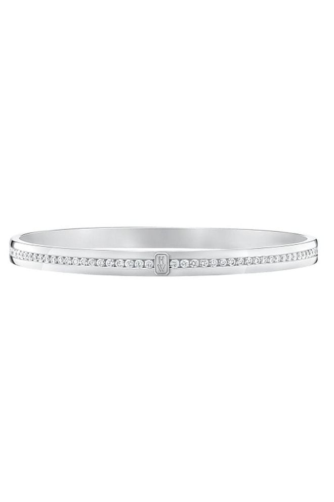 Wear this Harry Winston white-gold logo bracelet on its own or stacked. 