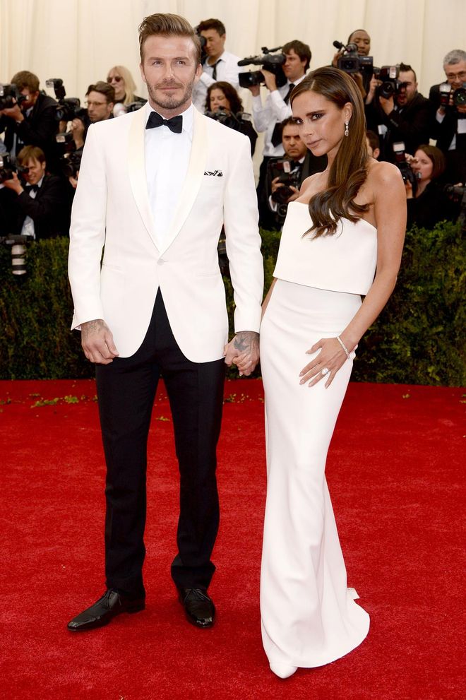 One thing David Beckham has become known for is coordinating with his wife Victoria. Here, he is wearing a white tux to match her gown at the Met Gala earlier this year.