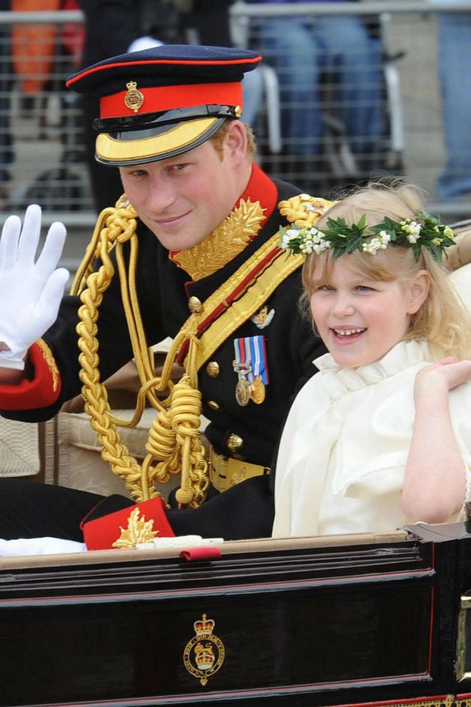 Prince Harry and Lady Louise Windsor greet the crowd from their carriage.Photo: Getty