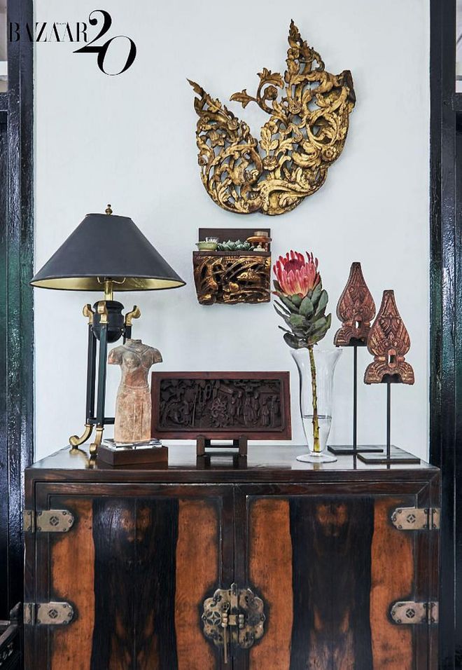 Various objects of Southeast Asian heritage sit on an antique Korean persimmon chest, with a gilded 19th-century
Burmese wood carving hanging above.

(Photo: Phyllicia Wang)