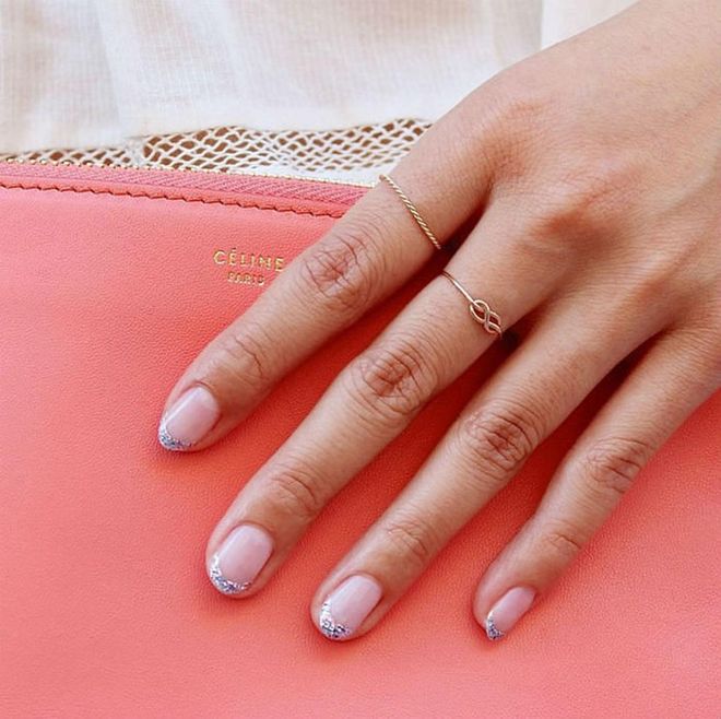 To pull off sparkly tips in a sophisticated way, pick a sheer base color and keep the length short and the shape round.  
@paintboxnails