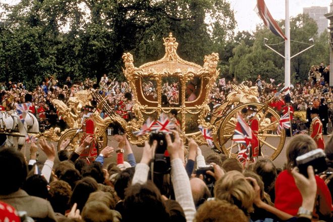 The Queen greets the crowds in her gilded state coach during her Silver Jubilee procession, June 1977.