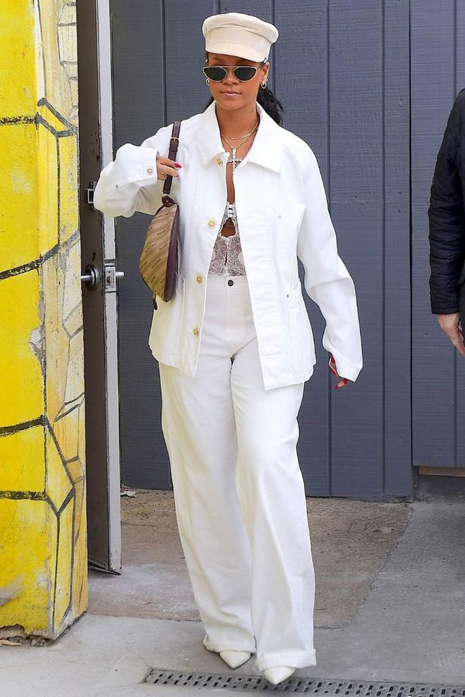 Rihanna wears a baggy ensemble matching a white denim jacket with high-waisted pants and co-ordinates it with a Balenciaga bag, newsboy cap and Alain Mikli x Alexandre Vauthier 'Nadège' sunglasses.
Photo: Courtesy