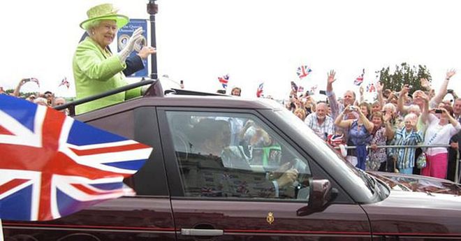 The Queen waving out a car on a visit to Stormont Castle in Belfast during her Diamond Jubilee year of 2012.