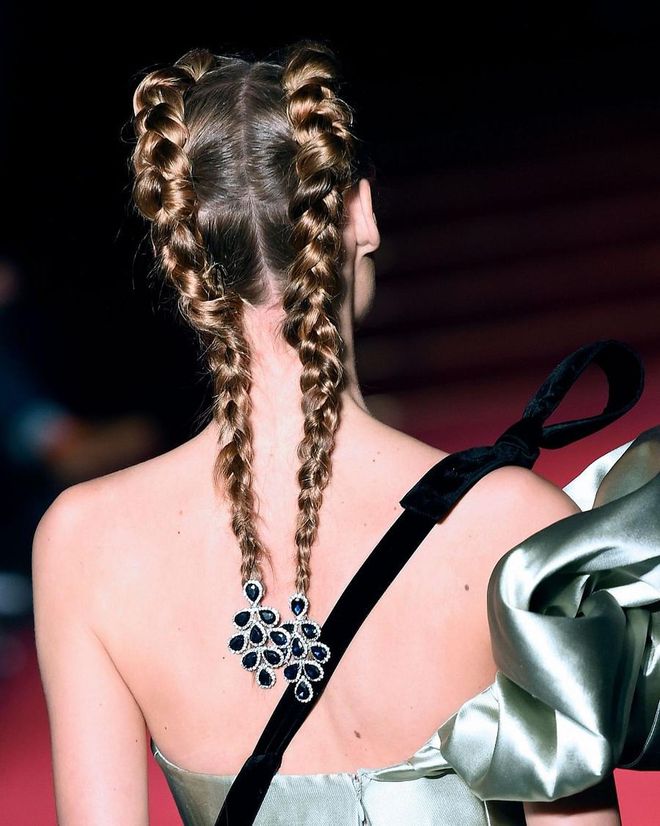Inside-out braided pigtails at Alexis Mabille got a couture upgrade with the addition of chandelier earrings secured at the ends. Think of this style as the new go-to for women without pieced ears, or for those among us find earrings in our ears to be quite uncomfortable. Why should they go to waste when thy go go in your hair?