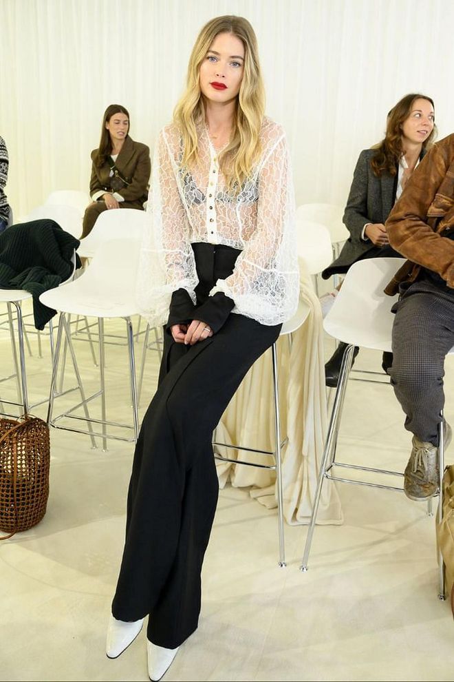 Doutzen Kroes teamed black tailored trousers with a white lace top for the Loewe show.

Photo: Getty