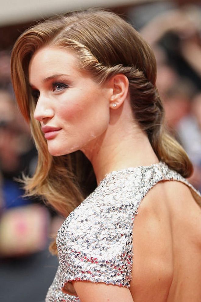 The style: The model accessorised her signature side-parting with an elegant twist. Photo: Getty