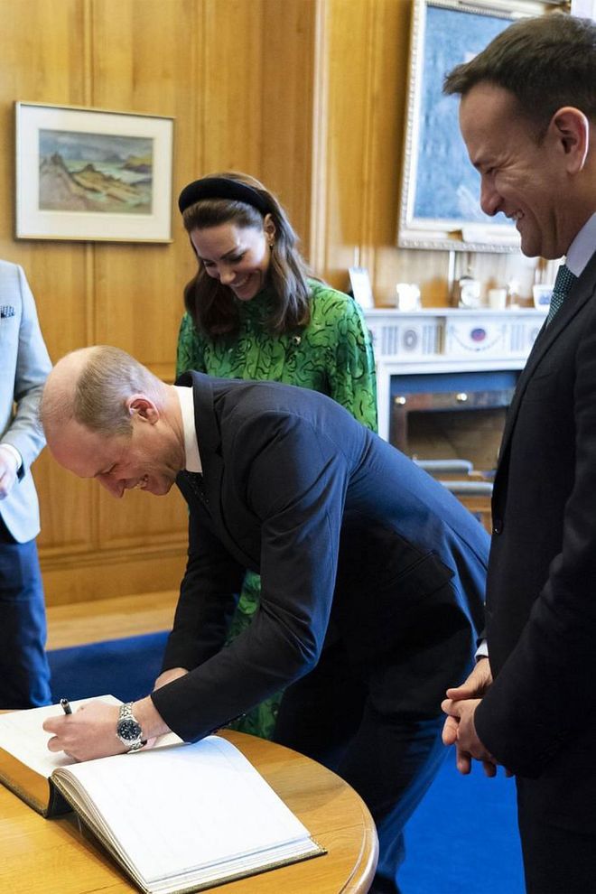 William also signs the visitors' book.

Photo: Getty