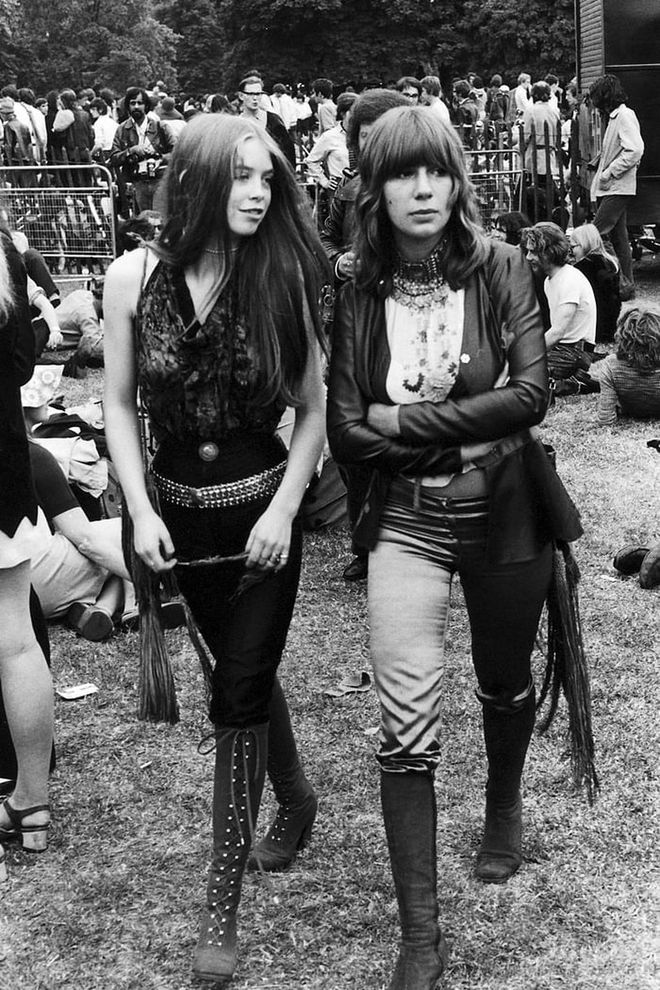 Two concert-goers in leather, studs and fringe attend a music festival in Hyde Park. Photo: Getty 