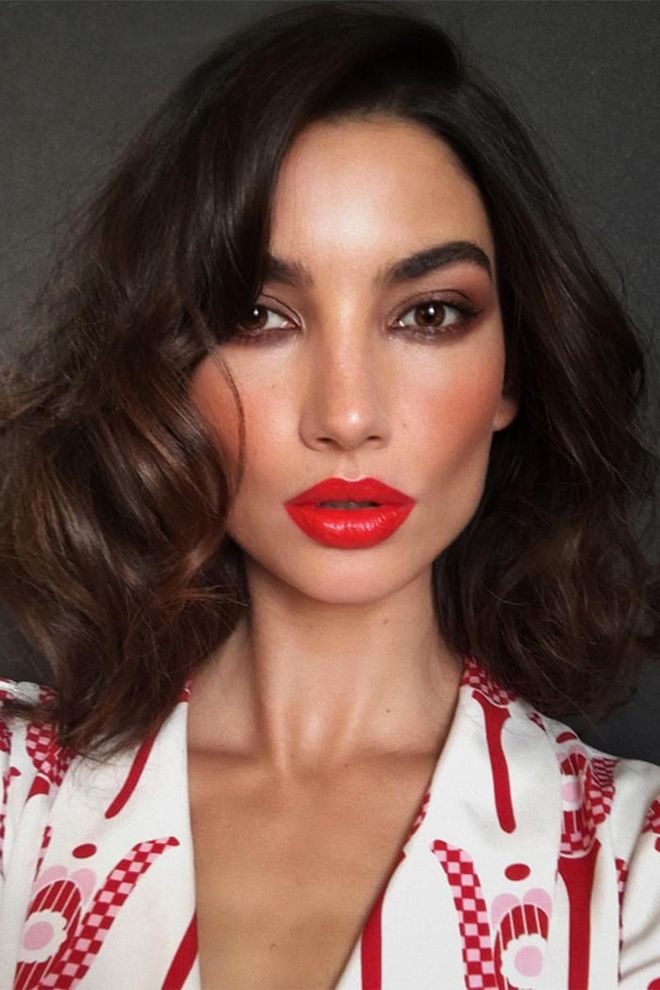 Lily Aldridge wearing a poppy-red lipstick by makeup artist Hung Vanngo on Instagram.
