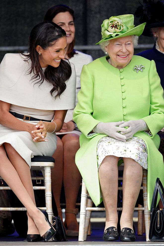 Just about a month after her wedding to Prince Harry, Meghan Markle stepped out for her first solo event with Queen Elizabeth II. Aside from being the first of the Fab Four to ride overnight on the Queen's private train, the two shared so many sweet bonding moments as they opened Mersey Gateway Bridge. While Meghan sported another custom Givenchy dress, she also wore a stunning gift from the Queen: a set of pearl-and-diamond earrings.