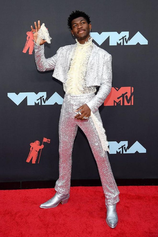 In a silver sequin suit and metallic cowboy boots.

Photo: Getty