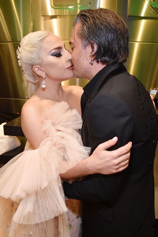Here, engaged couple Lady Gaga and Christian Carino embrace backstage at the 60th Annual Grammy Awards in New York City. Carino, who proposed to Gaga in 2017, took the couple’s PDA to the next level when he got a tattoo of his fiancée’s face (and possibly even inspired Ariana Grande and Pete Davidson to do the same). Photo: Getty