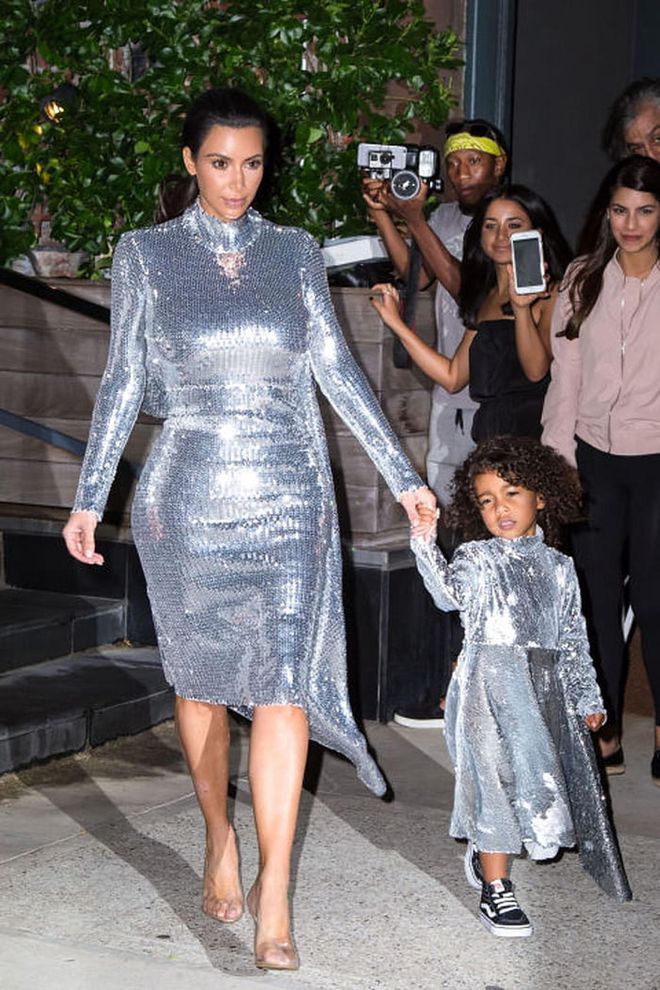 For a night out at Kanye West's Madison Square Garden concert, Kim Kardashian and North West stepped out in matching silver sequin Vetements dresses. While Kim topped hers off with a pair of Yeezy heels, North went for a more laid-back look in a pair of Vans. Ugh, don't you hate it when your mom steals your outfit? 
