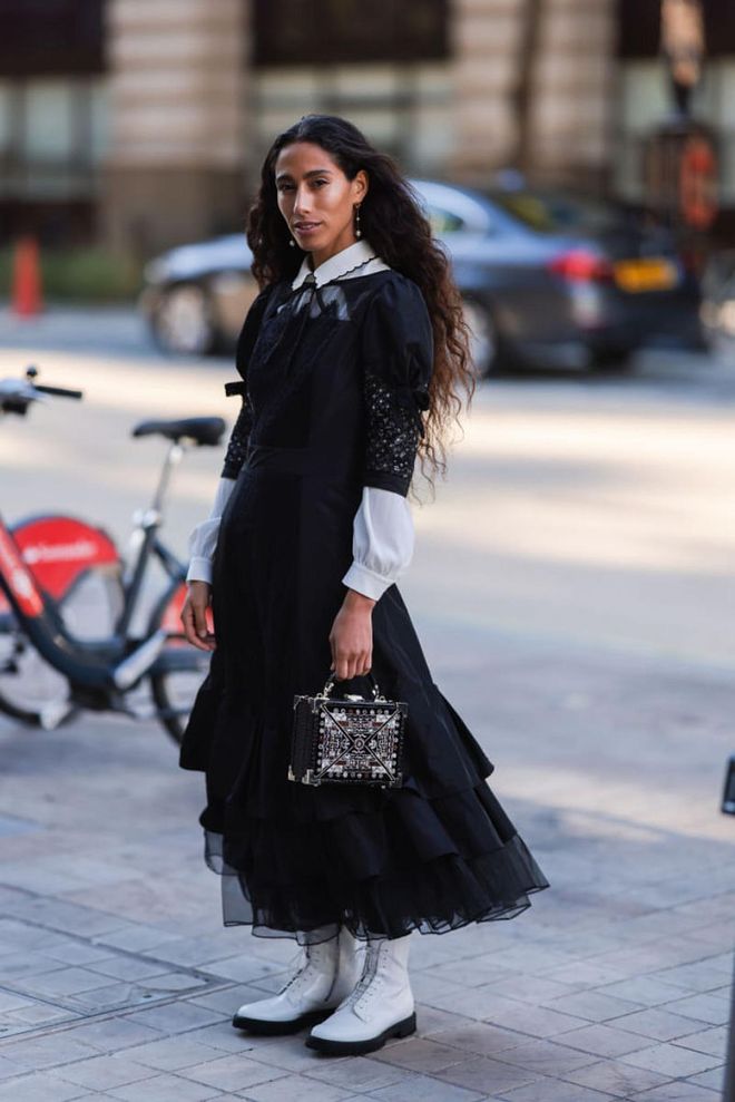 LONDON, ENGLAND -SEPTEMBER 16: Ciinderella Balthazar is seen wearing a white blouse, black ruffled tulle long dress, black embroidered box bag and white leather boots, outside Mark Fast during London Fashion Week on September 16, 2022 in London, England. (Photo by Jeremy Moeller/Getty Images)
