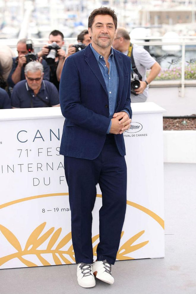 9 May: Her husband and co-star Javier Bardem arrived wearing a navy suit, which he paired with a denim shirt and white trainers. Photo: Getty