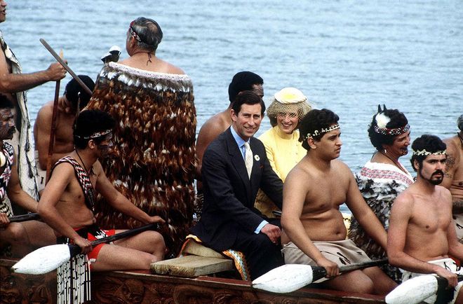 In a John Boyd yellow suit and hat while riding in a Maori canoe at the Bay Of Islands, New Zealand with Prince Charles. Photo: Getty