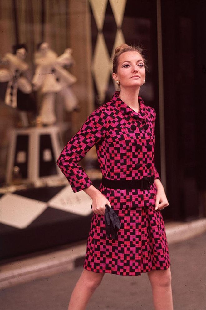 A woman in a pink and black checkered skirt suit. Photo: Getty 