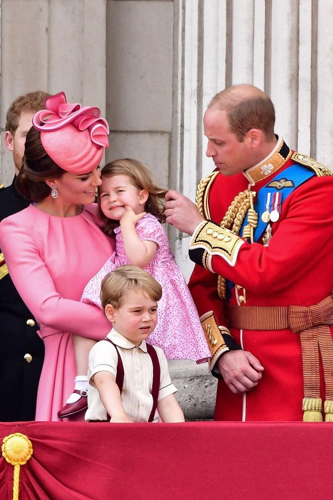 William fixes Charlotte's hair as the family stands on the balcony of Buckingham Palace for the 2017 Trooping the Colour parade in London.
Photo: Getty