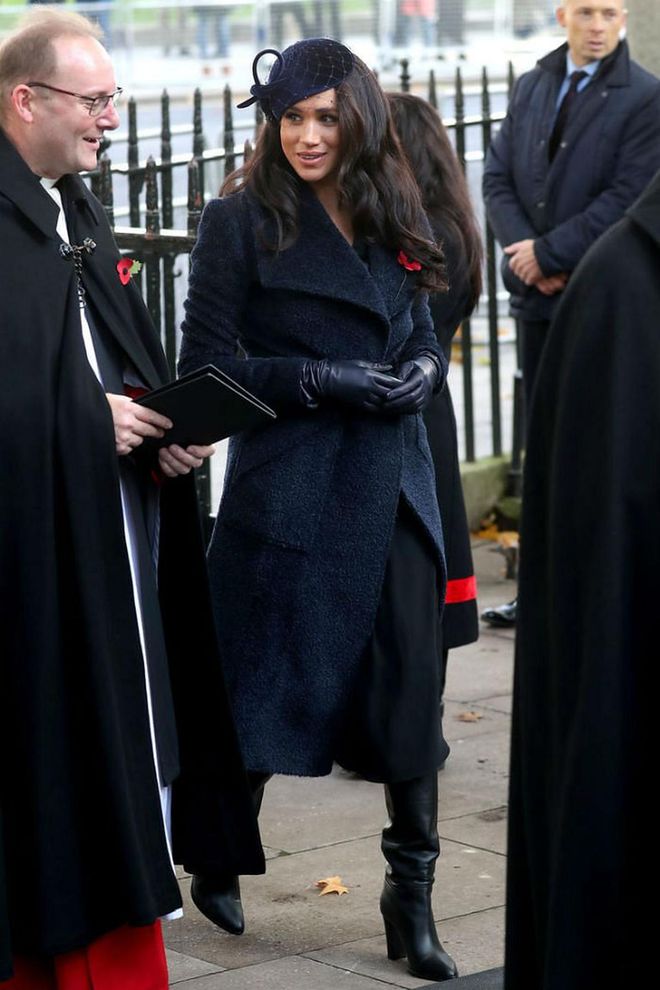 The duchess was dressed in a dark blue coat by Sentaler, black leather boots, leather gloves, and a velvet hat for a visit to the Field of Remembrance at Westminster Abbey.