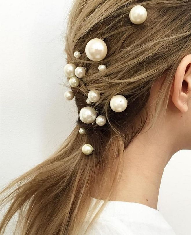 Skip the pearl jewelry and wear them in your hair, instead. Giant pearl pins look best when done in several sizes and scattered in a random fashion. Photo: @allenthomaswood