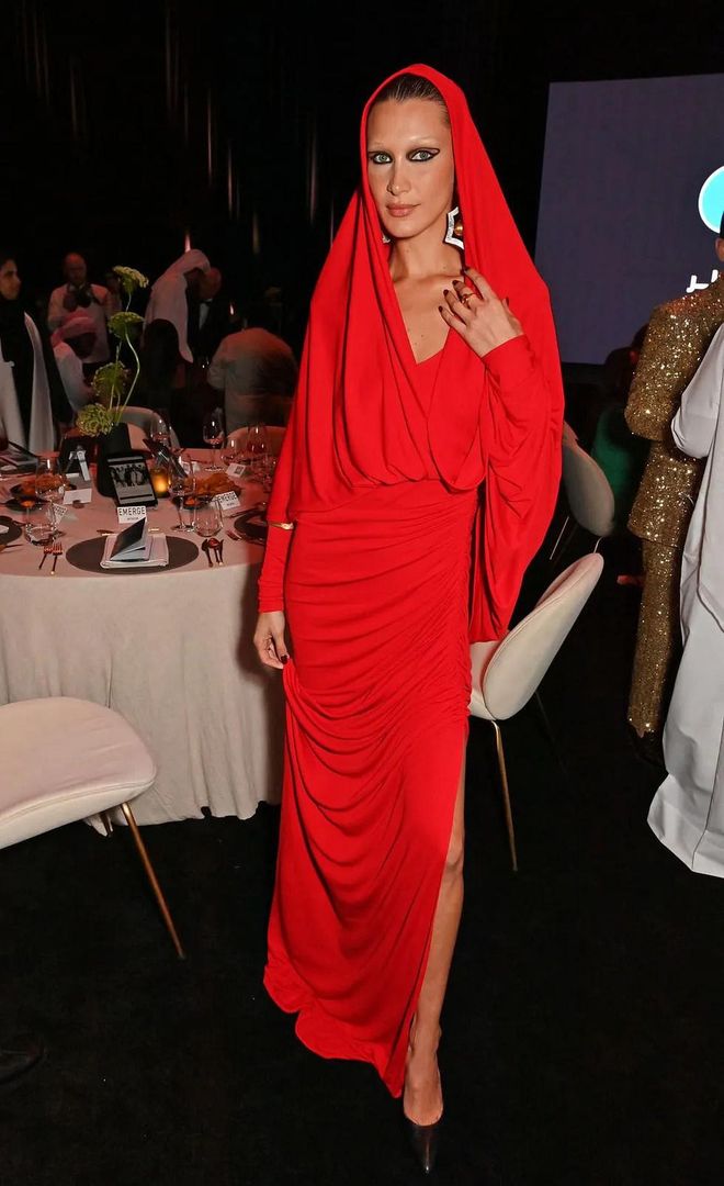Bella Hadid wearing a red hooded gown from Schiaparelli’s spring 2023 collection on a recent trip to Qatar. Photo: David M. Benett