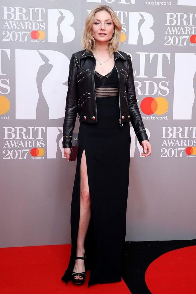 Clara Paget covered her floor-length dress with a black leather jacket. Photo: Getty