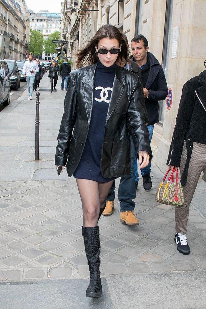 Bella sports a navy Chanel turtleneck dress paired with Fendi boots and a leather Balenciaga jacket. 