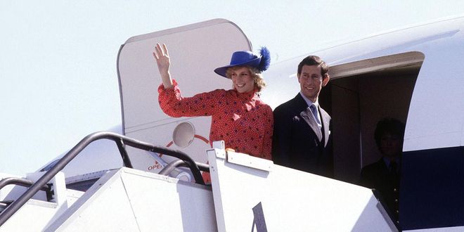 Waving goodbye in a red dress and blue feathered hat as she and Princess Charles leave Melbourne, Australia. Photo: Getty