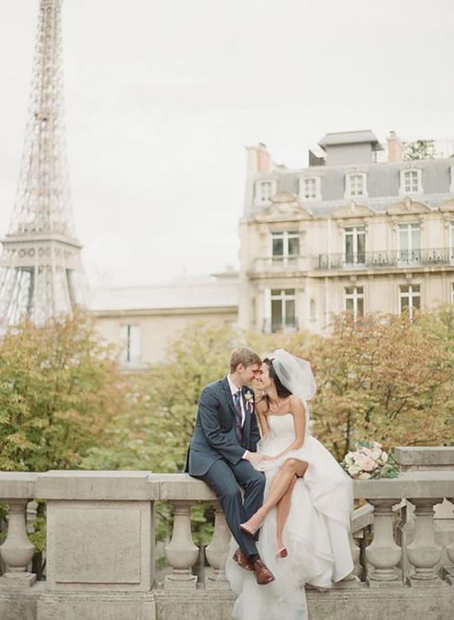 With the Eiffel Tower and the rooftops of Paris surrounding them, it's no wonder this happy couple is all smiles on the day of their intimate nuptials with just 40 guests.

Via Greg Finck

